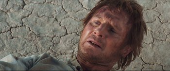 Movie still from “Seraphim Falls” (2006), directed by David Von Ancken – A person laying on the ground; Close Up shot, Low angle