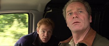 Movie still from “Session 9” (2001), directed by Brad Anderson – Two people in a car looking at the camera; Close Up shot, Low angle