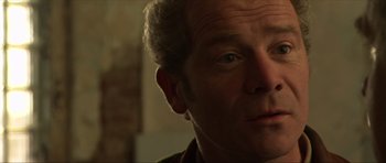 Movie still from “Session 9” (2001), directed by Brad Anderson – A person with a beard; Close Up shot, Over the shoulder angle