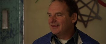 Movie still from “Session 9” (2001), directed by Brad Anderson – A person wearing a blue shirt; Close Up shot, Low angle