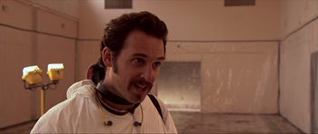 Movie still from “Session 9” (2001), directed by Brad Anderson – A man with a beard and a white shirt; Close Up shot, Over the shoulder angle