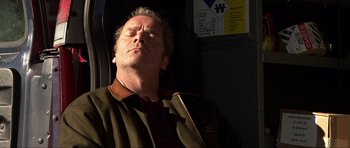 Movie still from “Session 9” (2001), directed by Brad Anderson – A person sleeping on a bus; Close Up shot, High angle