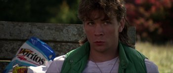 Movie still from “Session 9” (2001), directed by Brad Anderson – A young man wearing a white shirt and a green vest; Close Up shot, Over the shoulder angle