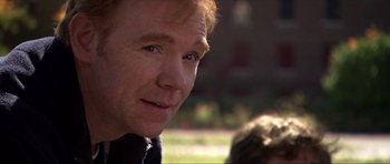 Movie still from “Session 9” (2001), directed by Brad Anderson – A man's face in a park; Close Up shot, Over the shoulder angle