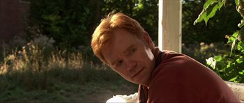Movie still from “Session 9” (2001), directed by Brad Anderson – A person with red hair; Close Up shot, Over the shoulder angle