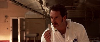 Movie still from “Session 9” (2001), directed by Brad Anderson – A man holding a piece of paper in his hand; Close Up shot, Low angle