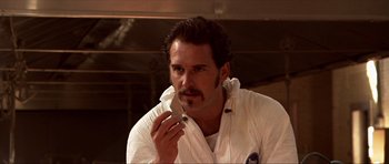 Movie still from “Session 9” (2001), directed by Brad Anderson – A man holding a knife up to his mouth; Close Up shot, Low angle