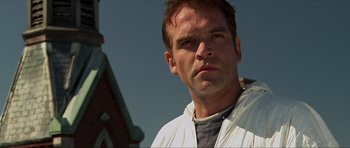 Movie still from “Session 9” (2001), directed by Brad Anderson – A person wearing a white jacket; Close Up shot, Low angle