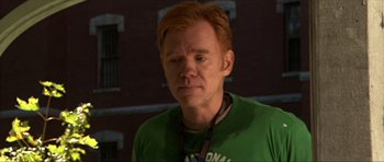 Movie still from “Session 9” (2001), directed by Brad Anderson – A red headed man wearing a green t - shirt; Close Up shot, High angle