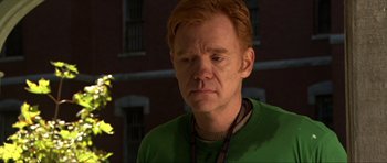 Movie still from “Session 9” (2001), directed by Brad Anderson – A man with ginger hair wearing a green sweater; Close Up shot, High angle