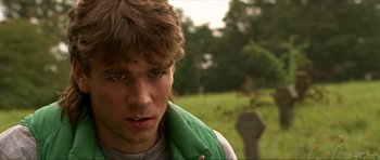 Movie still from “Session 9” (2001), directed by Brad Anderson – A young man in a green jacket is looking at the camera; Close Up shot, Over the shoulder angle