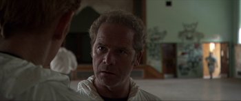 Movie still from “Session 9” (2001), directed by Brad Anderson – A person wearing a white jacket; Close Up shot, Over the shoulder angle