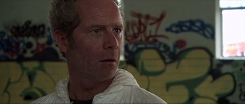 Movie still from “Session 9” (2001), directed by Brad Anderson – A person wearing a white jacket; Close Up shot, Low angle