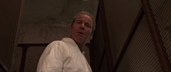 Movie still from “Session 9” (2001), directed by Brad Anderson – A person wearing a white shirt; Close Up shot, Low angle