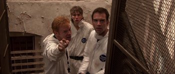 Movie still from “Session 9” (2001), directed by Brad Anderson – A group of men in white lab coats in a room; Medium shot, High angle
