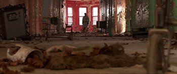 Movie still from “Session 9” (2001), directed by Brad Anderson – A man is standing in the middle of a room; Wide shot, Low angle