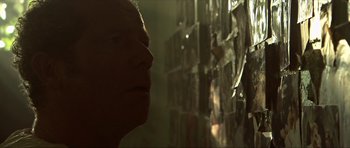 Movie still from “Session 9” (2001), directed by Brad Anderson – A man looking up at a wall of glass; Close Up shot, Over the shoulder angle