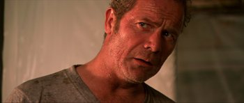 Movie still from “Session 9” (2001), directed by Brad Anderson – A man's face in a gray shirt; Close Up shot, Over the shoulder angle