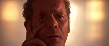 Movie still from “Session 9” (2001), directed by Brad Anderson – A man's face with blood all over his face; Extreme Close Up shot, Low angle