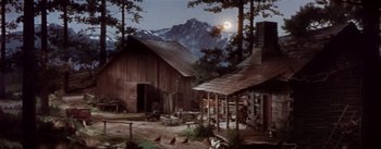 Movie still from “Seven Brides for Seven Brothers” (1954), directed by Stanley Donen – An image of an old farm setting with mountains in the background; Extreme Wide shot, High angle