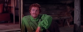 Movie still from “Seven Brides for Seven Brothers” (1954), directed by Stanley Donen – A man in a green shirt is looking up; Close Up shot, Low angle