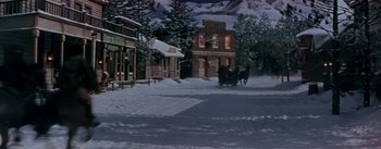 Movie still from “Seven Brides for Seven Brothers” (1954), directed by Stanley Donen – A horse drawn carriage traveling down a snowy street; Extreme Wide shot, High angle
