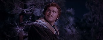 Movie still from “Seven Brides for Seven Brothers” (1954), directed by Stanley Donen – A person wearing a coat and a mustache; Close Up shot, Low angle