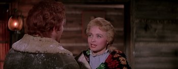 Movie still from “Seven Brides for Seven Brothers” (1954), directed by Stanley Donen – A woman in a floral jacket talking to another woman; Close Up shot, Over the shoulder angle