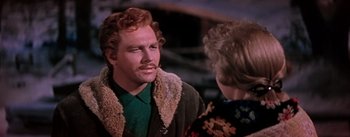 Movie still from “Seven Brides for Seven Brothers” (1954), directed by Stanley Donen – A man with a mustache talking to a woman; Close Up shot, Over the shoulder angle