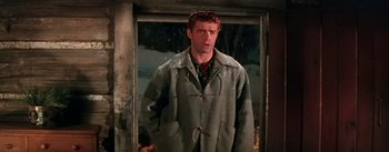 Movie still from “Seven Brides for Seven Brothers” (1954), directed by Stanley Donen – A man standing in front of an open door; Medium shot, Low angle