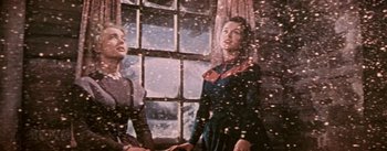 Movie still from “Seven Brides for Seven Brothers” (1954), directed by Stanley Donen – Two women standing next to each other in front of a window; Medium shot, Low angle