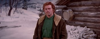 Movie still from “Seven Brides for Seven Brothers” (1954), directed by Stanley Donen – A man in a green shirt and a brown jacket; Medium shot, Low angle