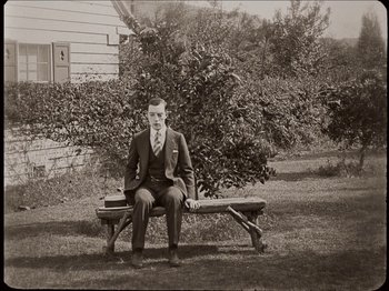 Movie still from “Seven Chances” (1925), directed by Buster Keaton – An old photo of a man sitting on top of a bench; Wide shot, High angle