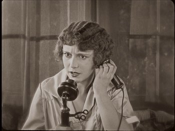 Movie still from “Seven Chances” (1925), directed by Buster Keaton – An old photo of a woman talking on a phone; Close Up shot, High angle