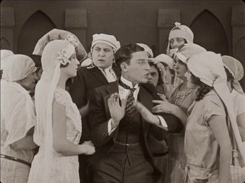 Movie still from “Seven Chances” (1925), directed by Buster Keaton – A group of men and women standing next to each other; Medium shot, High angle