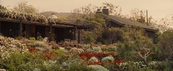 Movie still from “Seven Pounds” (2008), directed by Gabriele Muccino – A man sitting in the middle of a flower garden; Extreme Wide shot, High angle