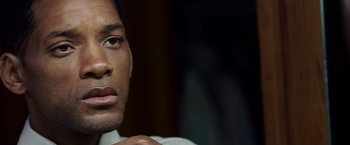 Movie still from “Seven Pounds” (2008), directed by Gabriele Muccino – A man's face in a dark room; Close Up shot, Over the shoulder angle