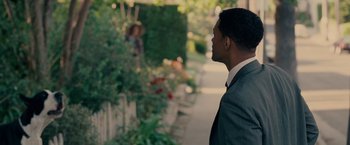 Movie still from “Seven Pounds” (2008), directed by Gabriele Muccino – A man standing on a sidewalk looking at a woman; Medium shot, Over the shoulder angle