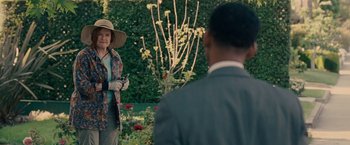 Movie still from “Seven Pounds” (2008), directed by Gabriele Muccino – A woman wearing a hat standing in front of a man; Medium shot, Over the shoulder angle