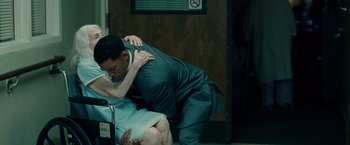 Movie still from “Seven Pounds” (2008), directed by Gabriele Muccino – A man and a woman are wrestling in a room; Medium shot, Over the shoulder angle