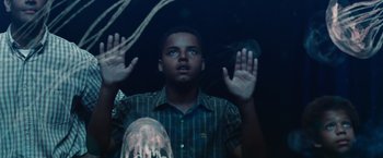 Movie still from “Seven Pounds” (2008), directed by Gabriele Muccino – A young man holding his hands up in the air; Medium shot, Low angle