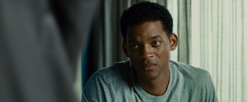 Movie still from “Seven Pounds” (2008), directed by Gabriele Muccino – A man sitting in front of a window looking sad; Close Up shot, Over the shoulder angle