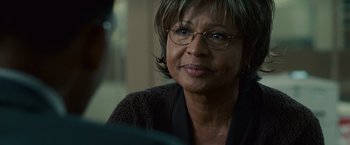 Movie still from “Seven Pounds” (2008), directed by Gabriele Muccino – An older woman wearing glasses looking at the camera; Close Up shot, Over the shoulder angle