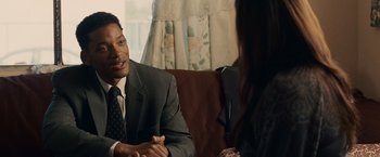 Movie still from “Seven Pounds” (2008), directed by Gabriele Muccino – A man in a suit and tie talking to a woman in a suit; Medium shot, Over the shoulder angle