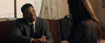 Movie still from “Seven Pounds” (2008), directed by Gabriele Muccino – A man in a suit and tie sitting next to a woman in a suit; Medium shot, Over the shoulder angle