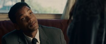 Movie still from “Seven Pounds” (2008), directed by Gabriele Muccino – A man wearing a suit and tie sitting next to another man; Close Up shot, Over the shoulder angle