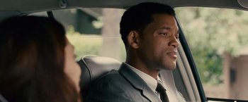 Movie still from “Seven Pounds” (2008), directed by Gabriele Muccino – A man sitting in a car wearing a suit and tie; Close Up shot, Over the shoulder angle