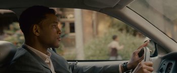 Movie still from “Seven Pounds” (2008), directed by Gabriele Muccino – A man in a suit sitting in the driver's seat of a car; Close Up shot, Over the shoulder angle