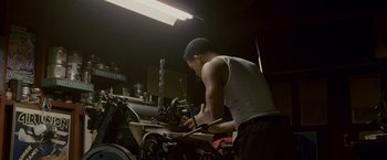 Movie still from “Seven Pounds” (2008), directed by Gabriele Muccino – A man working in a workshop on a machine; Medium shot, Low angle