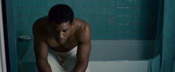 Movie still from “Seven Pounds” (2008), directed by Gabriele Muccino – A man sitting on a towel in a bath tub; Close Up shot, High angle